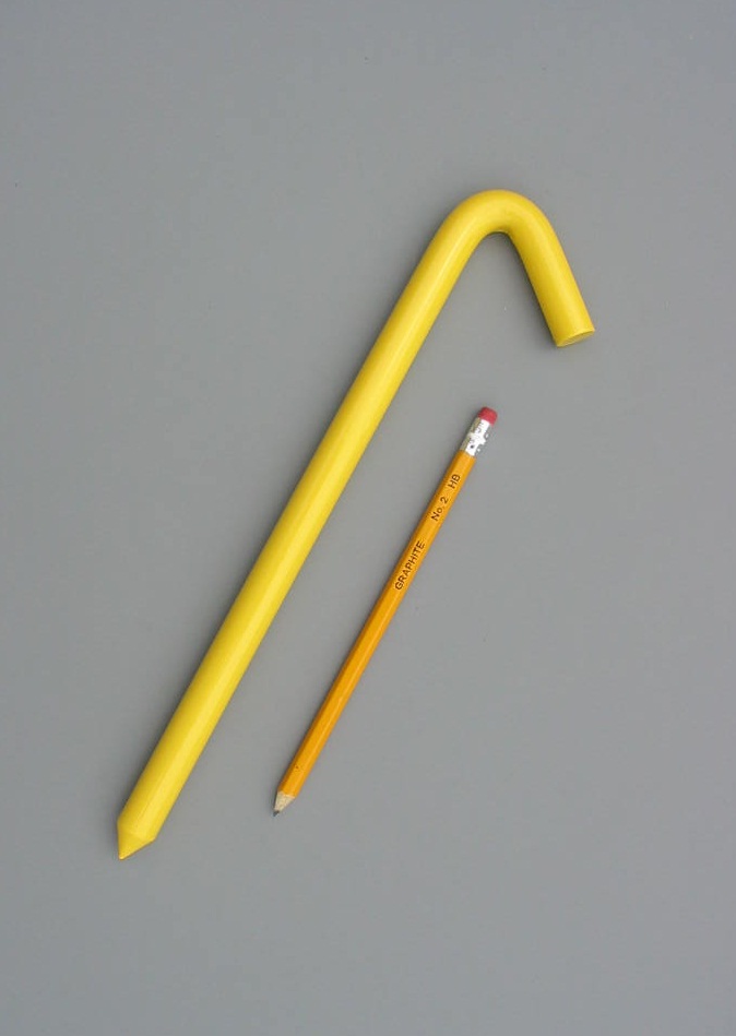 12 inch long hook style stake with a baked on safety yellow enamel paint with a pencil for scale
