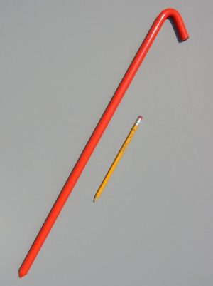 24 inch metal hook style tent stake in safety orange color and a pencil for scale