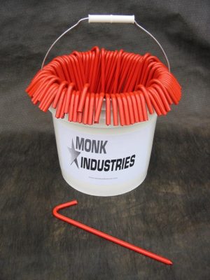 Bucket of 100 10 inch metal tarp stakes in orange color