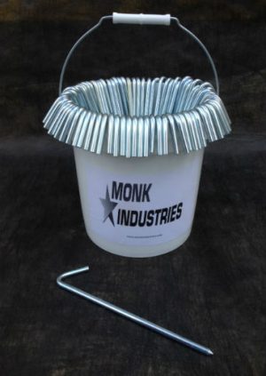 bucket with 100 zinc plated 10" long tarp stakes hanging off the sides