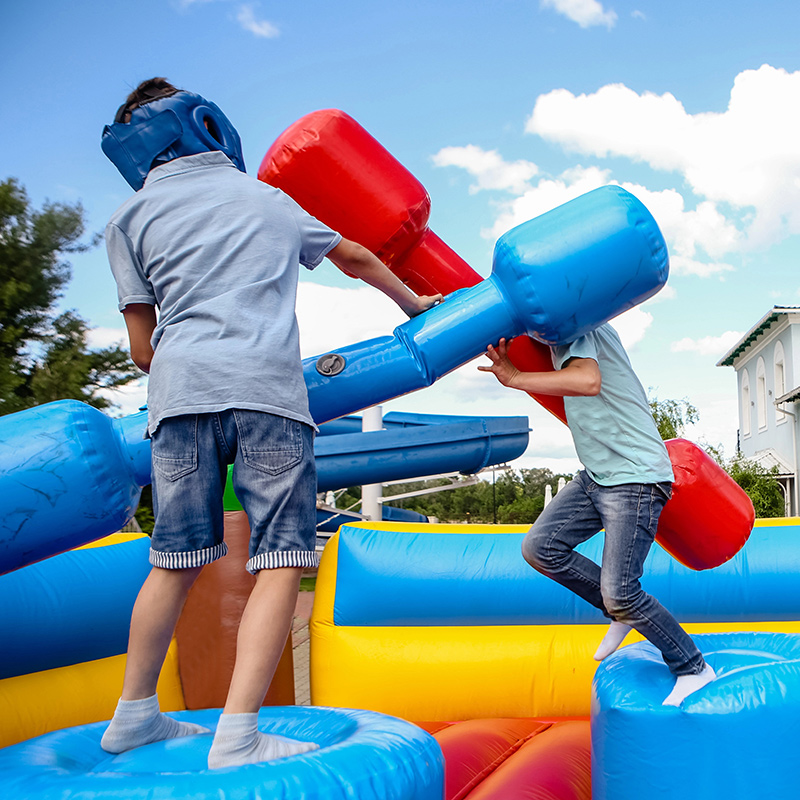 Two boys playing in an inflatable bounce tent playground